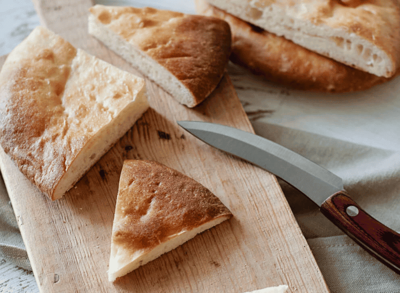 bread on cutting board making pita bread