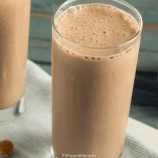 chocolate protein powder beside glasses of chocolate protein shake