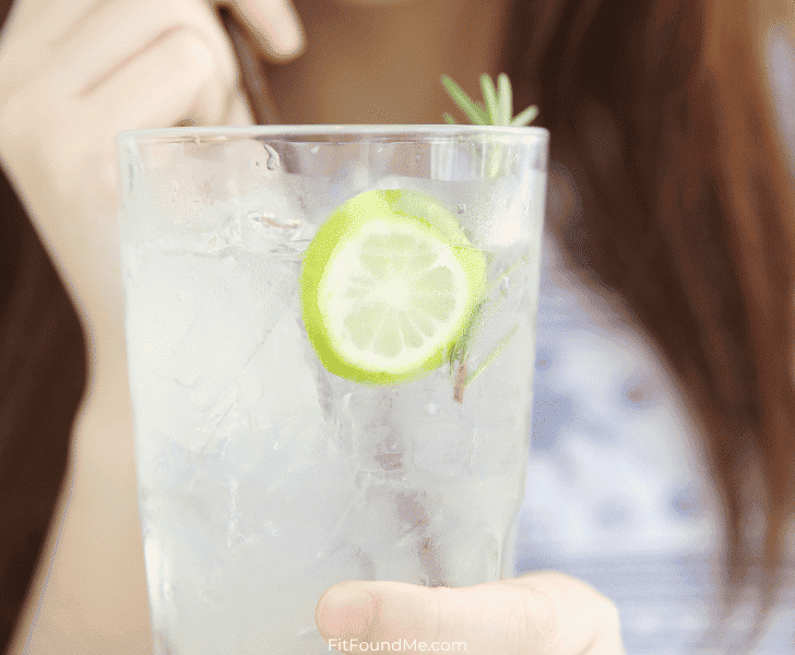 woman drinking sierra mist in glass with straw