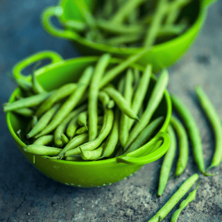 Fresh green beans on gray background
