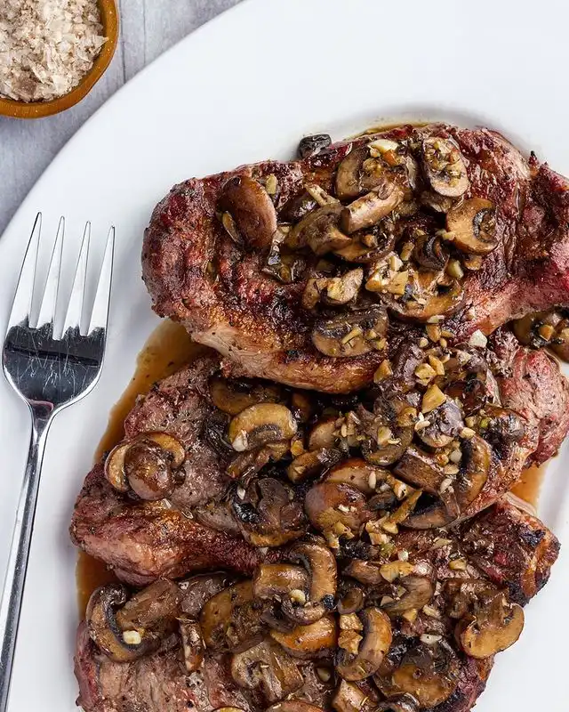 NY Strip with Saut&eacute;ed Garlic Mushrooms
