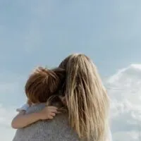 Back-view-of-mother-carrying-young-son-728×485