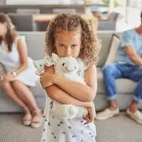 Sad,Girl,,Fighting,Parents,Thinking,Of,Divorce,In,Living,Room