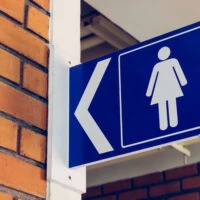 Restroom,Signs,With,Female,Symbol,And,Arrow,Direction,Signs
