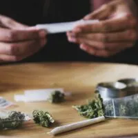 Person,,Hands,And,Rolling,Weed,For,Joint,In,House,,Cannabis