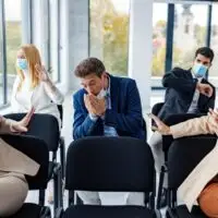 Risky,Symptoms,On,Seminar,Between,Business,People.,A,Businessman,Sneezing