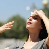 Stressed,Asian,Woman,Drying,Sweat,With,A,Cloth,In,A