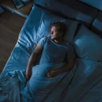 Top,View,Of,Handsome,Young,Man,Sleeping,Cozily,On,A